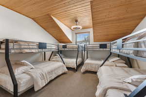 Bedroom featuring wood ceiling, lofted ceiling, and carpet floors