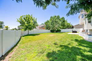 Fenced backyard with a patio