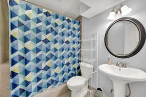 Bathroom with a shower with curtain and toilet