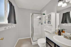 Bathroom featuring a shower stall and vanity