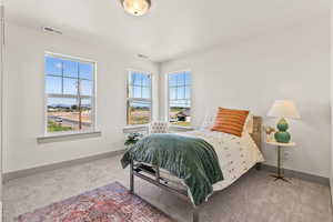Bedroom featuring carpet floors and baseboards