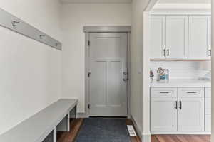 Mudroom with dark wood-style flooring