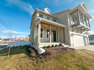 View of front of home with a front lawn, a porch, concrete driveway, and a garage