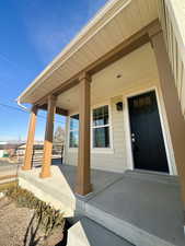 View of exterior entry with a porch