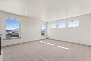 Spare room with light colored carpet and recessed lighting