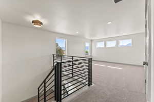 Empty room featuring light carpet and recessed lighting