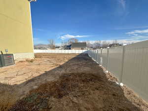 Fenced backyard featuring a residential view