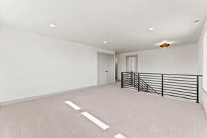 Spare room with light carpet and recessed lighting
