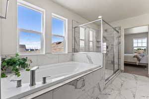 Ensuite bathroom featuring a marble finish shower, a bath, and light marble finish floors