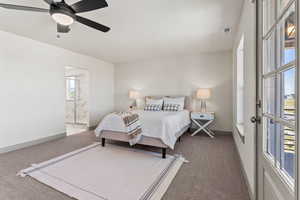 Carpeted bedroom with ceiling fan and ensuite bath