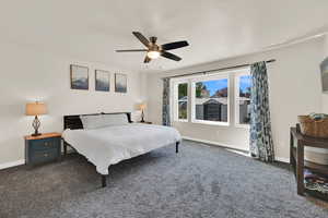 Primary bedroom with carpet flooring and ceiling fan