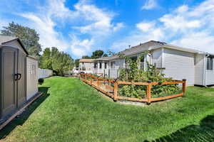 View of yard with a storage shed and a garden