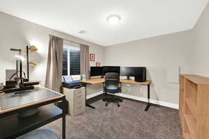 Office featuring light carpet and baseboards