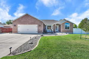 Ranch-style house featuring brick siding, driveway, a garage, RV parking, a shingled roof, and a patio