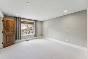 Spare room with carpet and recessed lighting