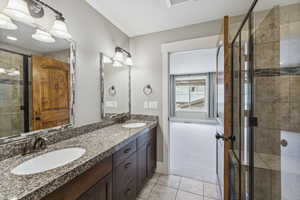 Full bathroom featuring light tile patterned floors and a shower stall