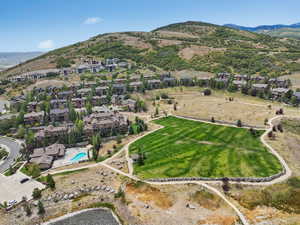 Aerial view of property's location with nearby suburban area and a mountain backdrop