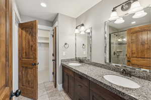 Full bathroom with a stall shower, light tile patterned floors, recessed lighting, and a spacious closet