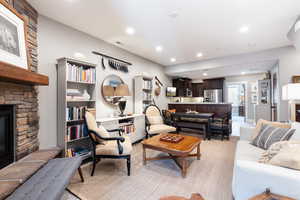 Living area with a fireplace and recessed lighting