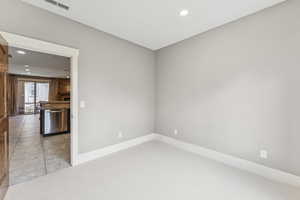 Unfurnished room with recessed lighting and light colored carpet