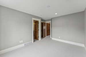 Empty room featuring carpet floors and recessed lighting