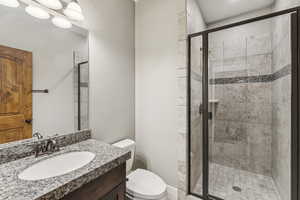 Bathroom with vanity and a stall shower