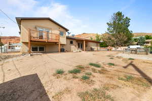 Rear view of house featuring stucco siding, a mountain view, and french doors