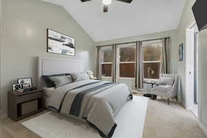 Owner's suite bedroom featuring light colored carpet, vaulted ceiling, and ceiling fan. Virtually staged photo