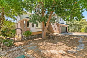 View of front of house featuring a garage, brick siding, and concrete driveway