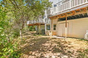 View of yard with a wooden deck and a patio