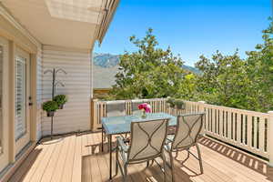 Wooden terrace with outdoor dining area and a mountain view