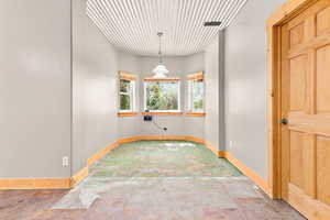 Unfurnished room with baseboards