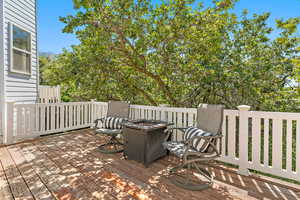 Wooden deck featuring an outdoor fire pit