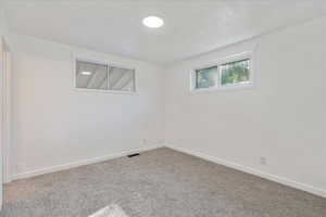 Basement featuring carpet flooring and baseboards