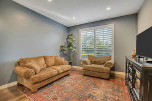 Living room featuring wood finished floors and recessed lighting