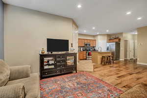 Living room with recessed lighting and light wood finished floors