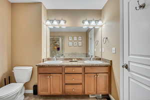 Owner's suite bathroom featuring a shower stall and double vanity