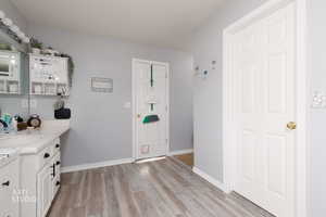 Entryway with baseboards and light wood-type flooring