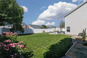 Fenced backyard with a garden and a patio