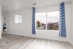 Unfurnished room with baseboards and wood finished floors