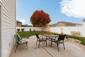 Fenced backyard featuring outdoor dining area and a patio