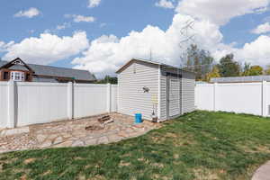 View of shed featuring a fenced backyard