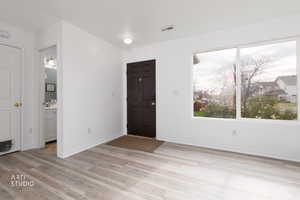 Entrance foyer featuring light wood-style flooring and baseboards