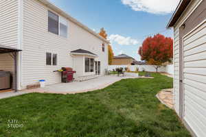 Rear view of house featuring a patio area and a fenced backyard