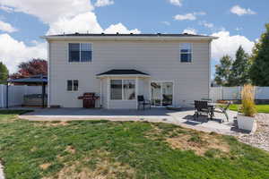 Back of property with a patio area, a hot tub, and a gazebo