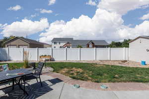 Fenced backyard with a patio area and outdoor dining space