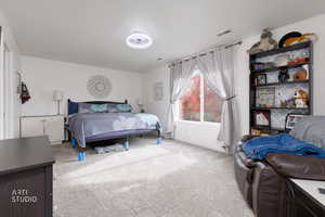 Bedroom with light carpet and baseboards