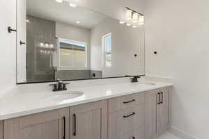 Bathroom with double vanity and recessed lighting