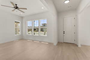 Entrance foyer with a ceiling fan, light wood finished floors, and recessed lighting