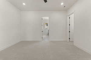 Empty room with light colored carpet, recessed lighting, and ceiling fan